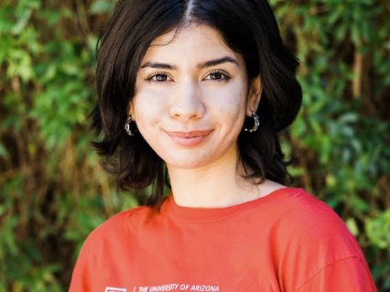 Iliana Samorano, photo of person in red T shirt in front of greenery