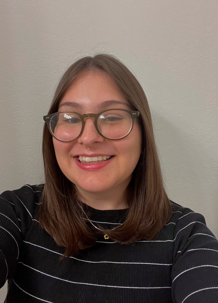 a photo of a person smiling in front of a blank background