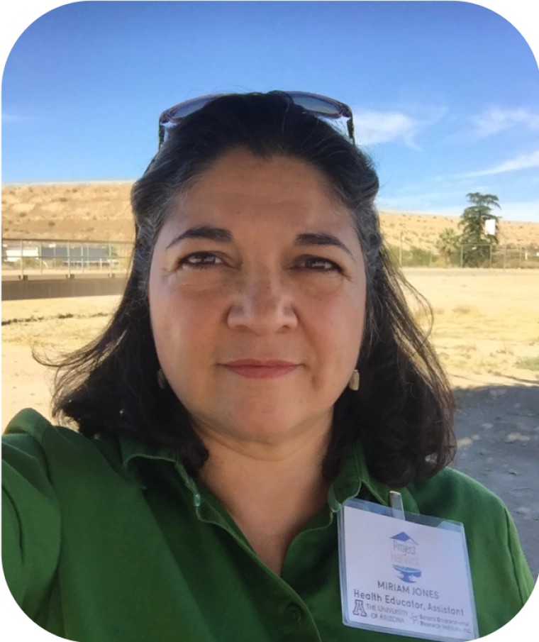 photo of a person in green blouse in front of an open field